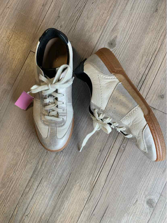 White leather sneakers with beige suede accents and gum rubber soles, size 10.