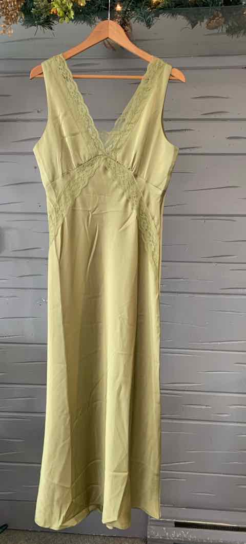 Light green sleeveless maxi dress with V-neck and gathered waist detail on wooden hanger.
