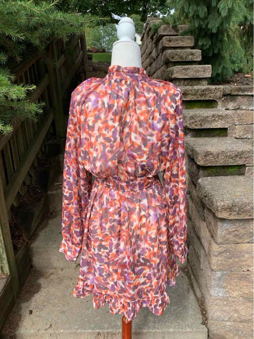 Long-sleeve mini dress with pink, purple, and orange abstract print and gathered waist elastic.