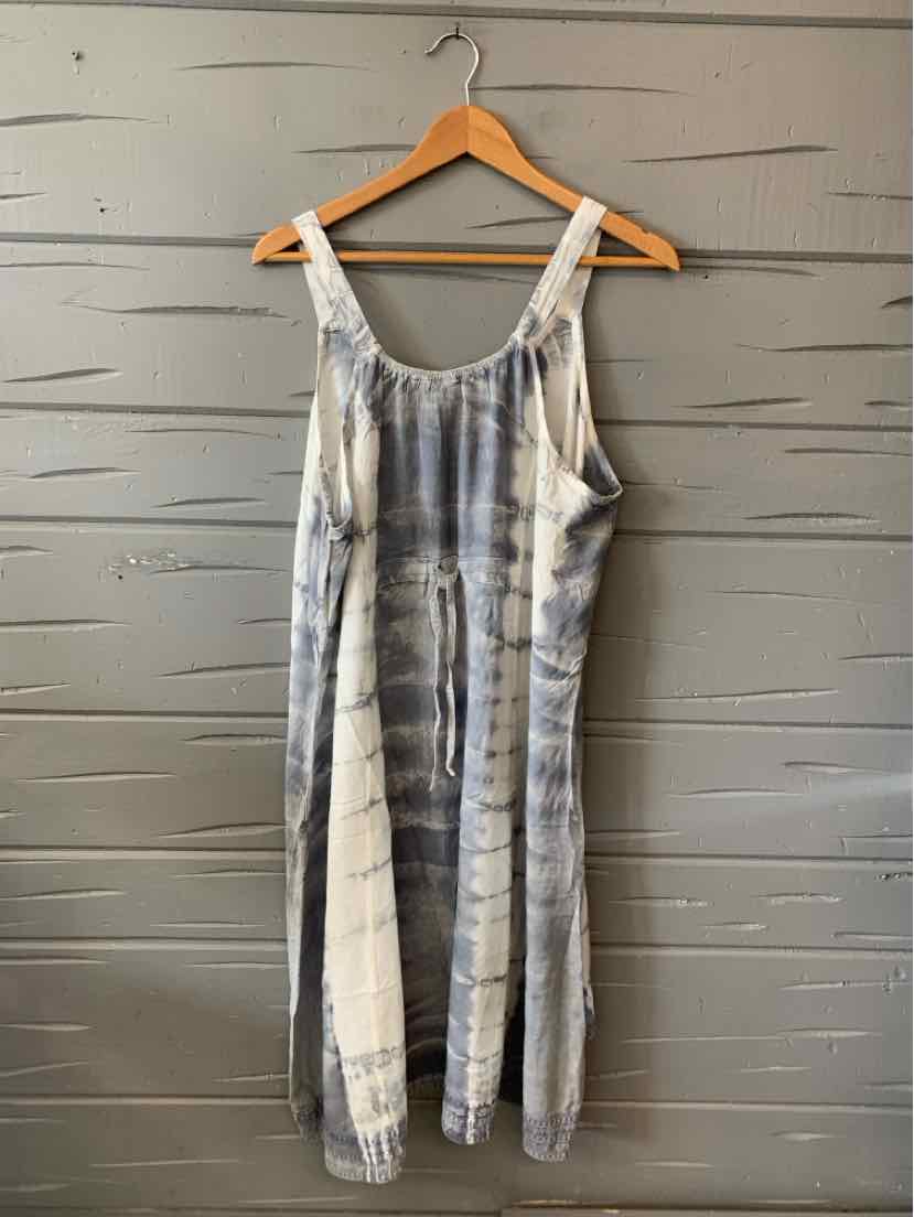 Sleeveless blue and white tie-dyed midi dress with a scoop neckline on a wooden hanger.