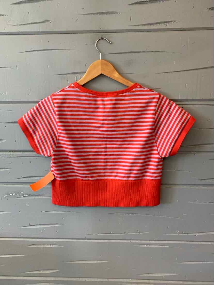 Red and white horizontal striped cropped T-shirt with solid red hem and short sleeves on wooden hanger.