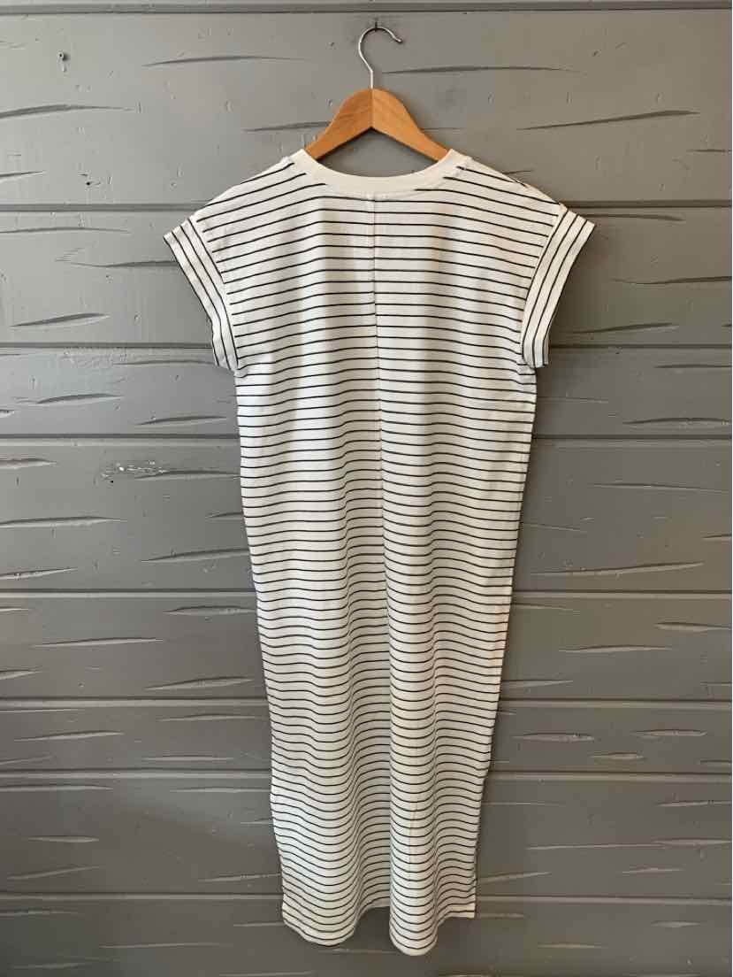 White midi dress with horizontal thin black stripes, sleeveless design, and relaxed fit.