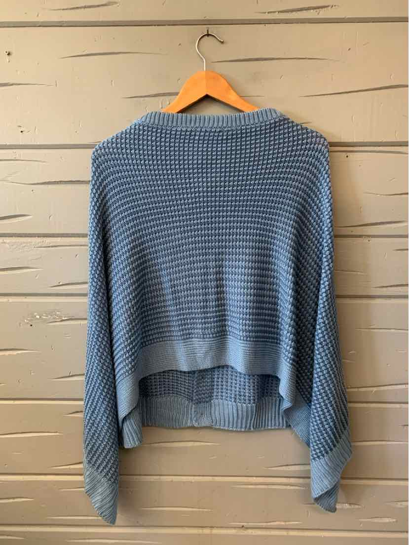 Blue textured knit poncho sweater with a draped silhouette, wide sleeves, and a high neckline.