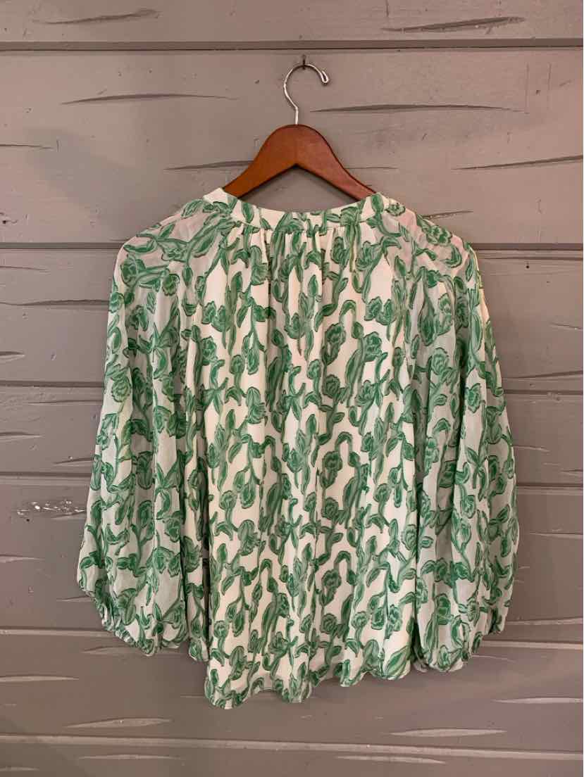 Green and white floral patterned blouse with long puffed sleeves and gathered cuffs.