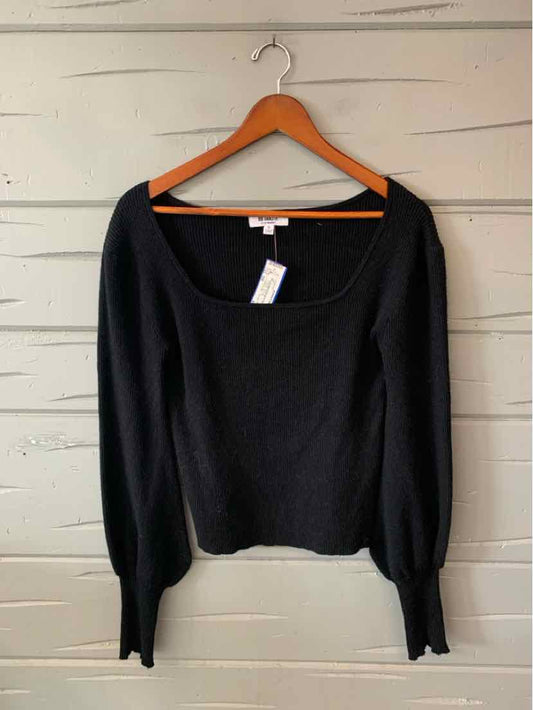 Black women’s long-sleeve knit top with a wide square neckline and fitted cuffs, displayed on a hanger.