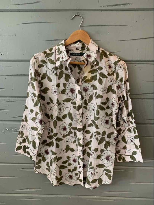 White button-up shirt with green and brown floral print, long sleeves, and a classic collar.