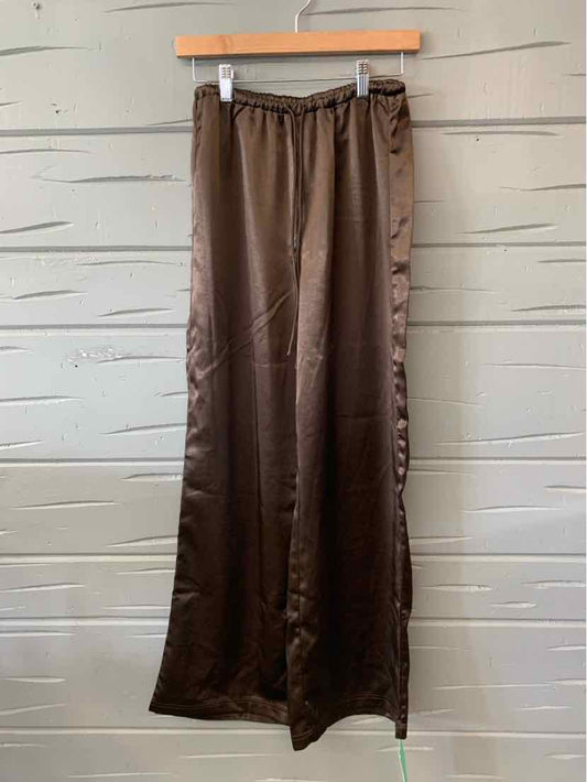 Brown satin wide-leg pants with elastic waistband, size 6, hanging on wooden hanger.