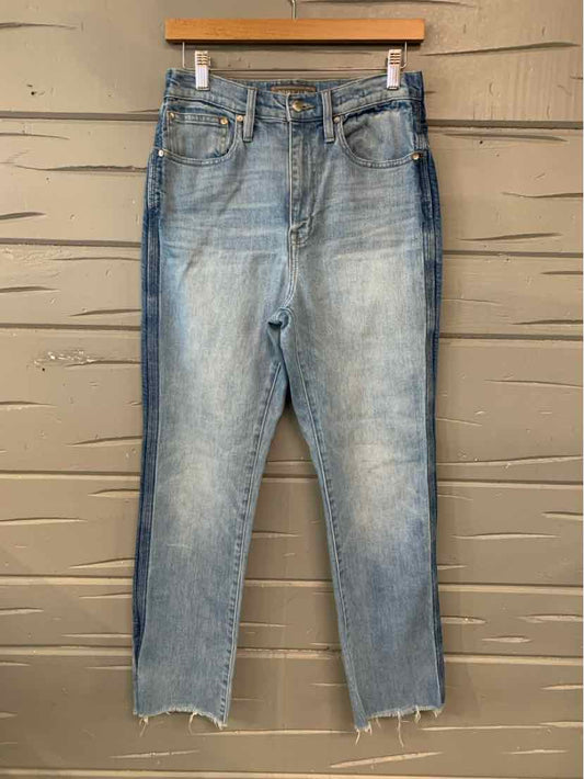Light blue denim jeans in size 4 with a slightly faded wash and raw hem detailing.