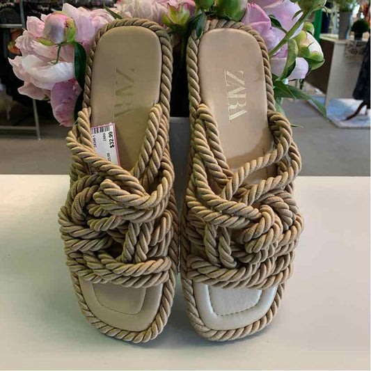 Beige square-toe woven rope sandals with flat soles and slip-on design.