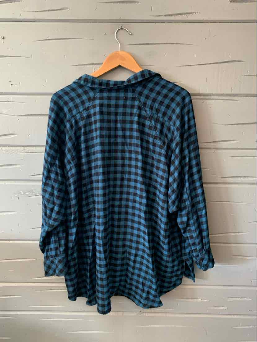 Blue and black checkered flannel shirt with long sleeves and a chest pocket hanging on a wooden hanger.