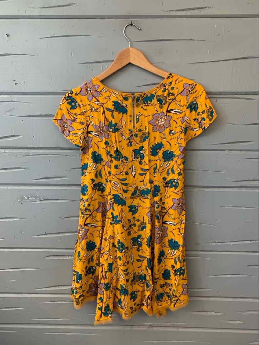 Yellow floral short-sleeve dress with blue and green flower print, fitted waist, and round neckline.