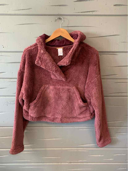 Mauve fleece pullover with half-zip, kangaroo pocket, and relaxed fit on wooden hanger.