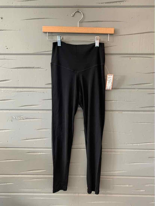 Black high-waisted leggings with subtle seam detailing and a fitted ankle cut.