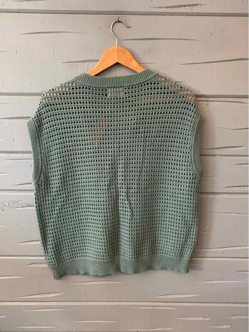 Light green open-knit short-sleeve sweater with ribbed hem and collar hanging on wooden hanger.