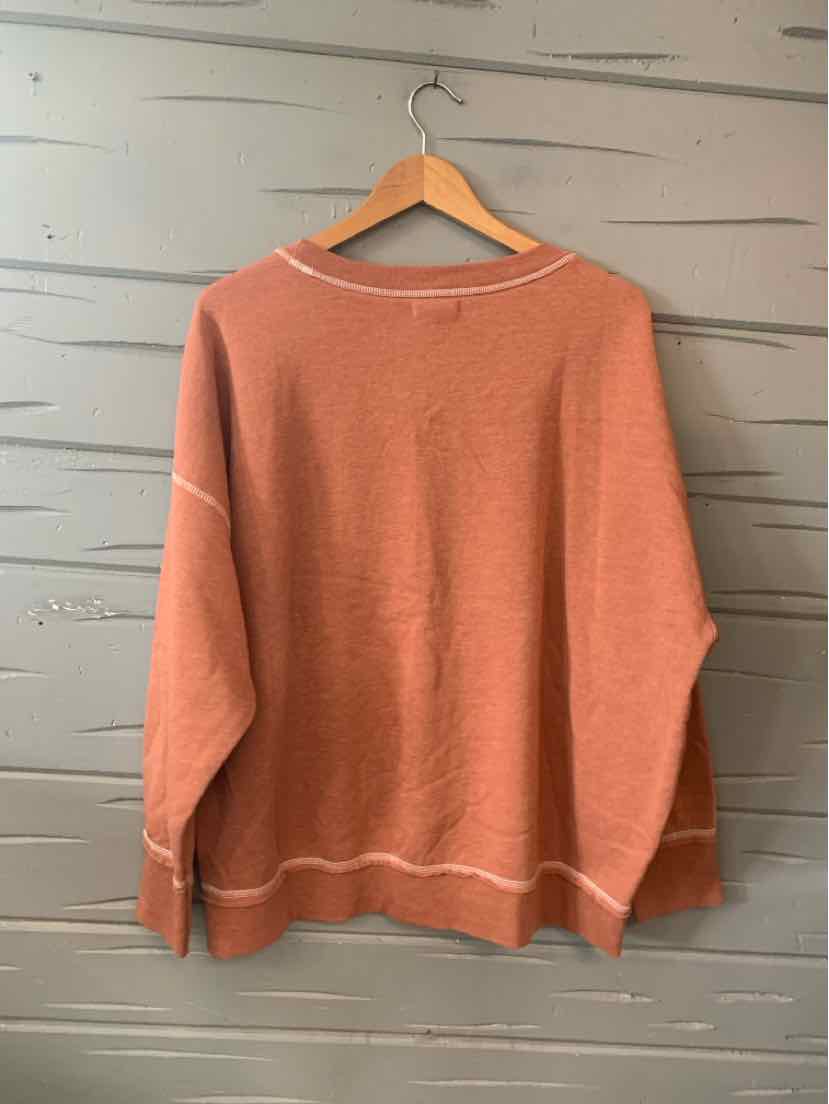 Loose-fit oversized long-sleeve sweater in dusty rose with white seam accents and crew neckline.