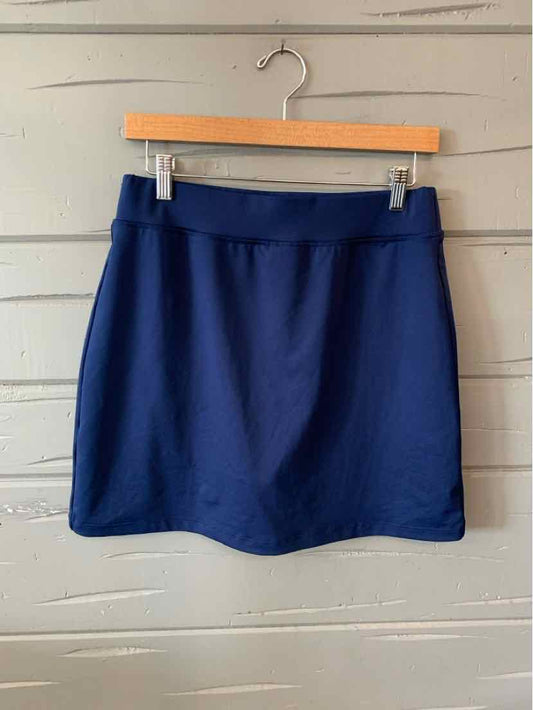 Navy blue, knee-length skirt with a straight cut and flat waistband, hanging on a wooden hanger.