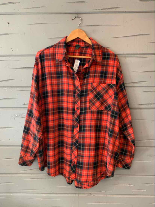 Red and black plaid button-up shirt with a pointed collar, chest pocket, and long sleeves.
