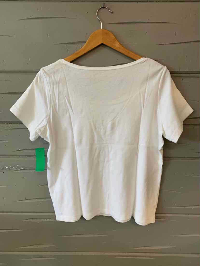 White short-sleeve casual top with loose fit on wooden hanger against gray wall.