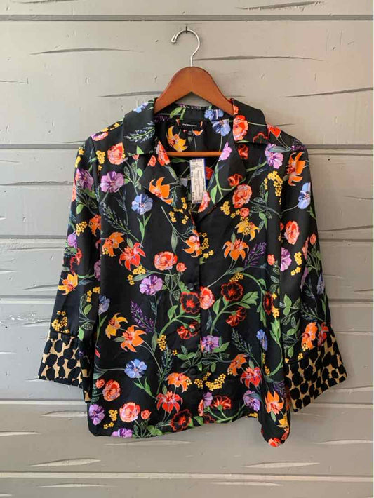 Black floral button-front blouse with a notched collar and long sleeves, covered in colorful flowers and leaves.