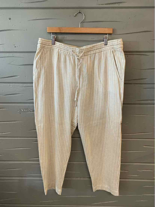 Tan tapered pants with thin white vertical stripes and an elastic waistband, size XL.