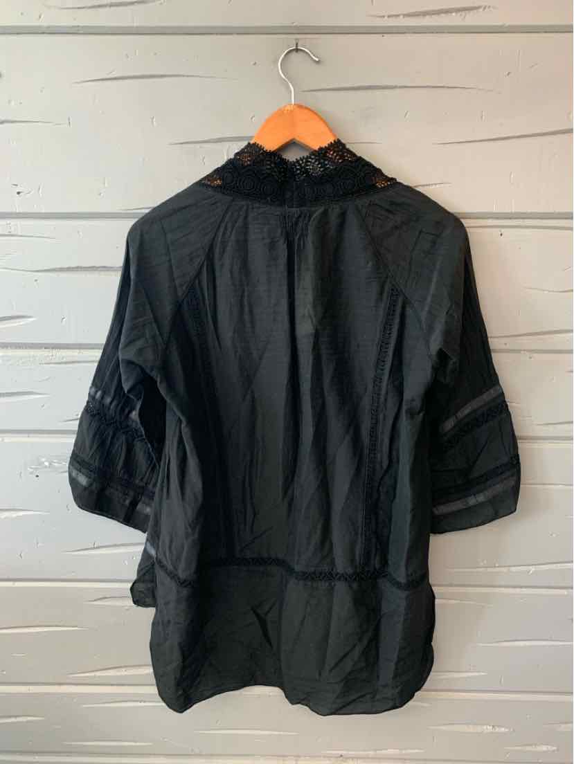Black lightweight blouse with lace collar and three-quarter sleeves on wooden hanger.