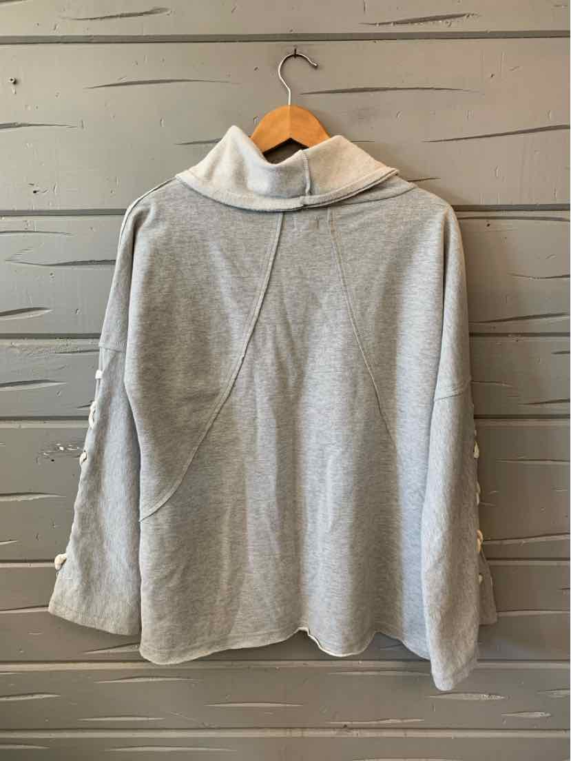 Light gray hooded sweatshirt with long sleeves and a relaxed fit, hanging on a wooden hanger.