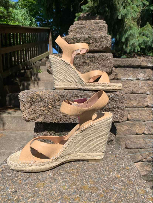 Tan wedge sandals with ankle straps and jute-wrapped platform heel, size 7.