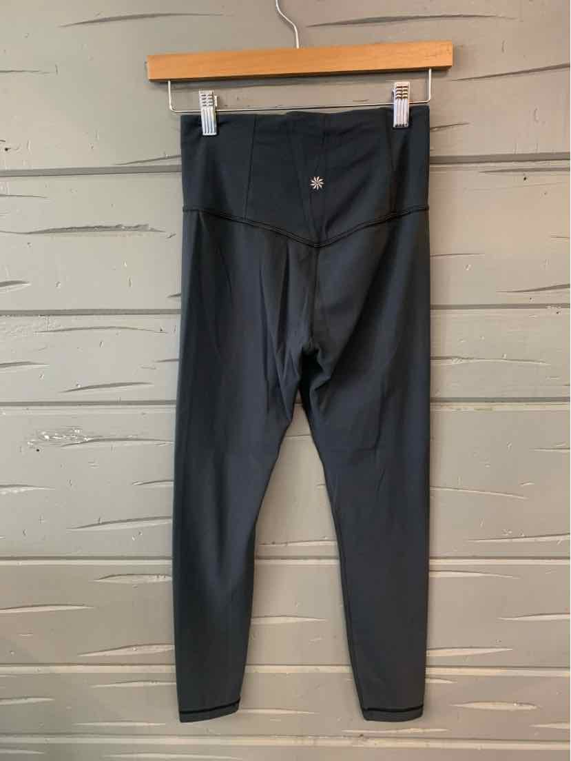 High-waisted solid gray athletic leggings with flat seams and a button detail on the back waistband.