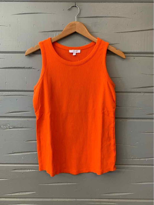 Orange sleeveless ribbed knit tank top on wooden hanger against gray wall.