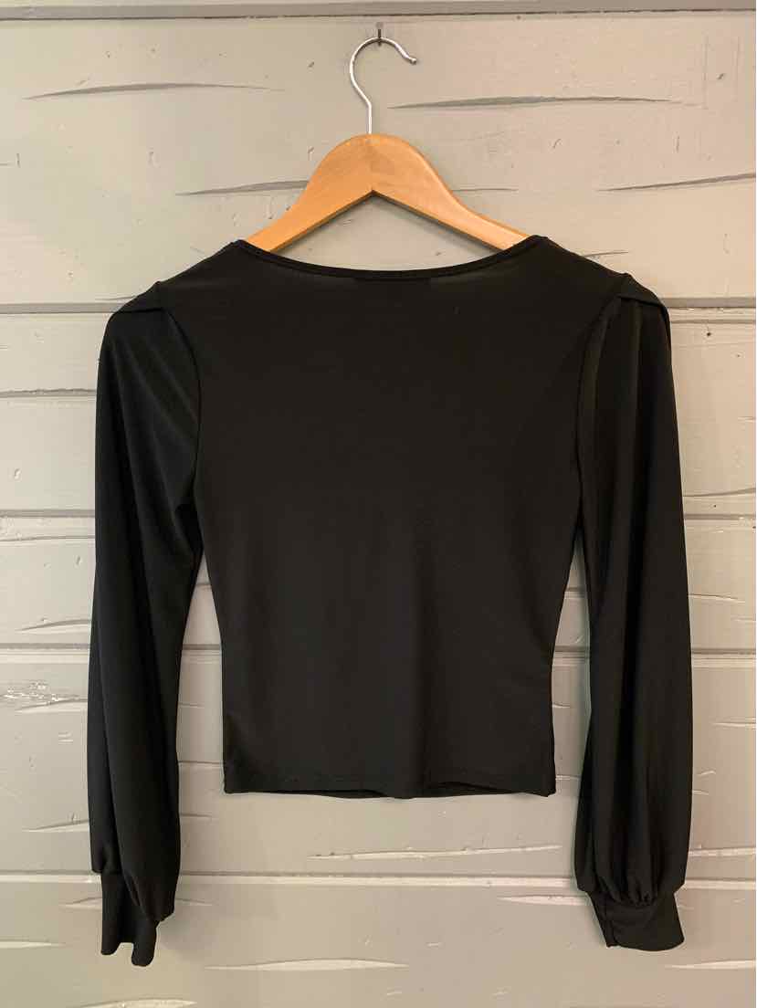 Black long-sleeve fitted shirt with a round neckline and subtle puffed cuffs on wooden hanger.