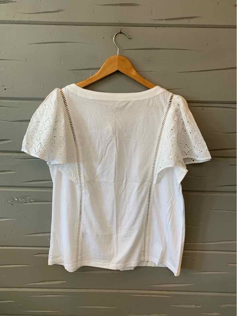 White short-sleeve blouse with lace puff sleeves and a square neckline, hanging on wooden hanger.