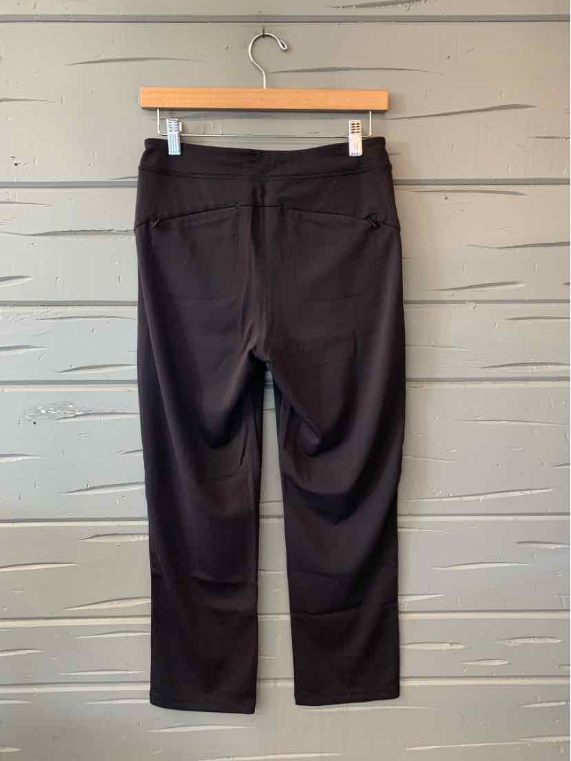 Black Athleta women's cropped athletic pants with a wide waistband and straight legs.