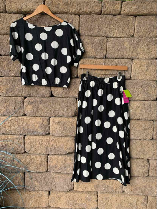 Black short-sleeve crop top and midi skirt set with large white polka dots on lightweight fabric.