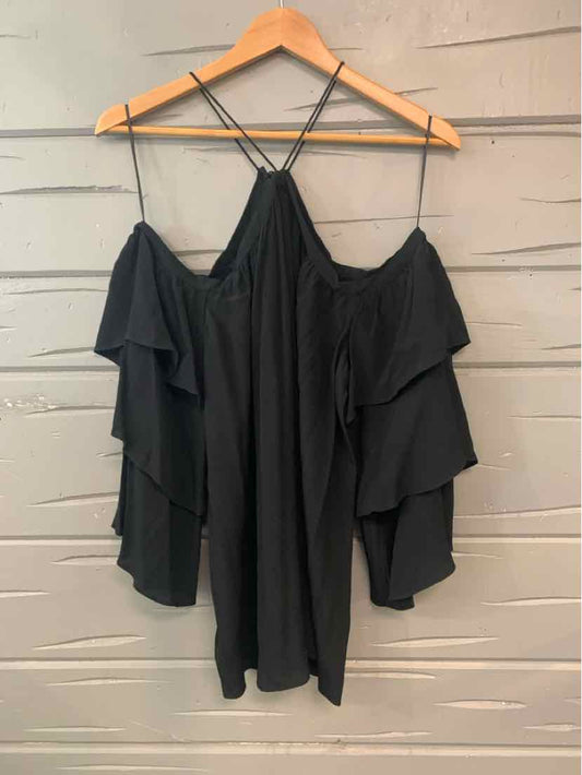Black off-shoulder top with tiered ruffle sleeves and thin crisscross straps, medium size.
