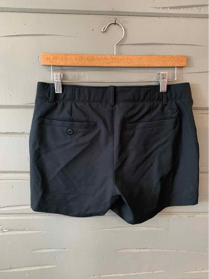 Black Under Armour athletic shorts with back buttoned pockets, elastic waistband, and lightweight fabric.