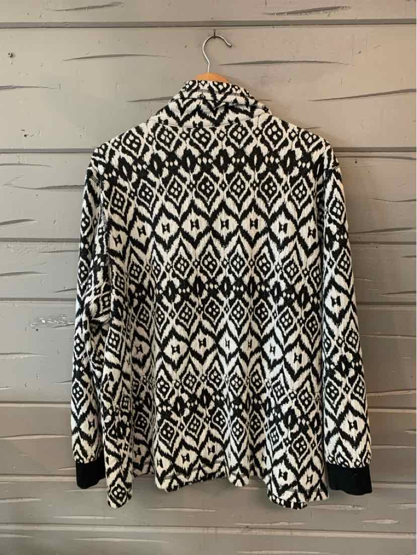 Black and white geometric patterned long-sleeve cardigan with a draped open front and relaxed fit.