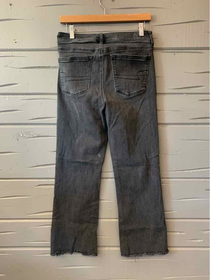 Gray denim jeans for women with a raw hem and classic back pockets, casual style.