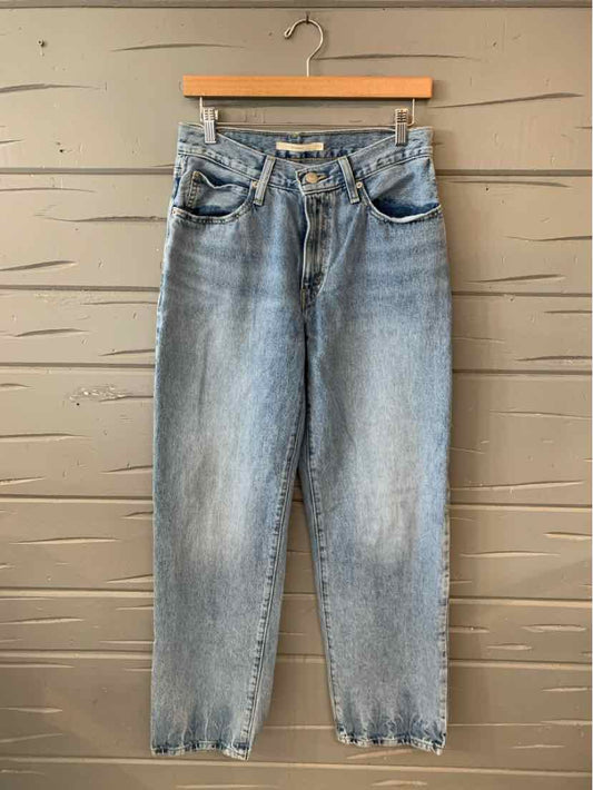 Light blue high-waist Levi's denim jeans with tapered legs and classic five-pocket design.