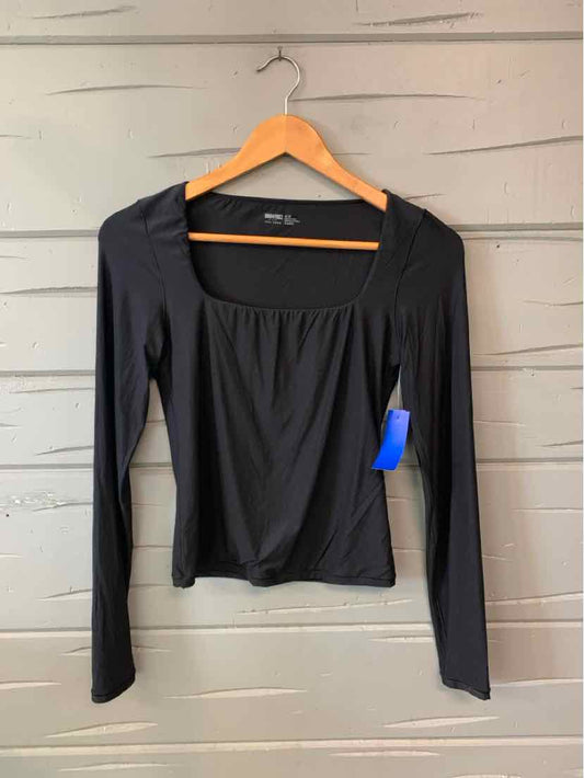 Black Aerie long-sleeve top with a wide square neckline and gathered front, hanging on a wooden hanger.