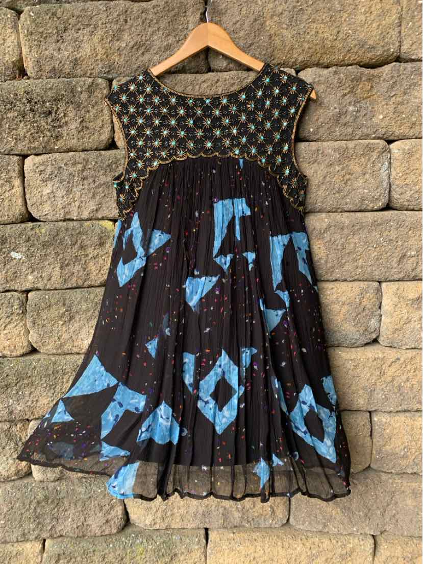 Black sleeveless dress with blue geometric patterns and beaded detailing on bodice.