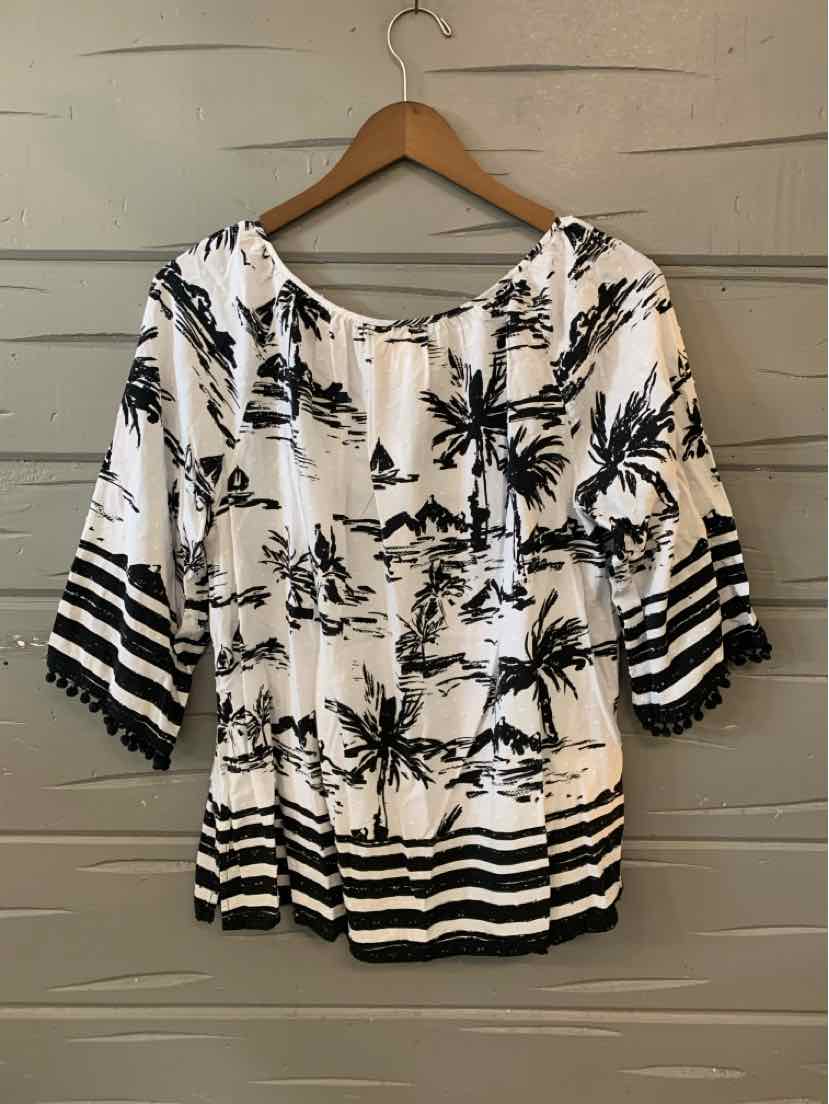 White blouse with black tropical palm prints, three-quarter sleeves, and striped hem and cuffs.