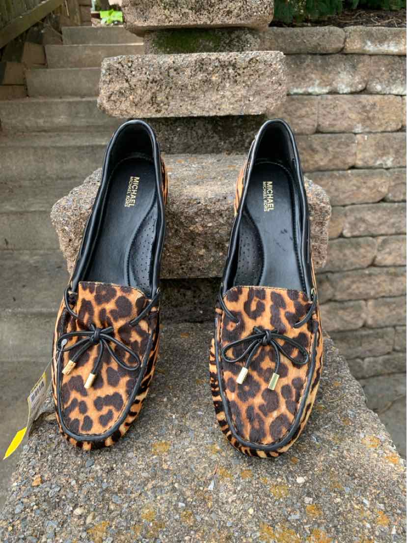Tan leopard print leather loafers with rounded toes and tassel detail, size 11.