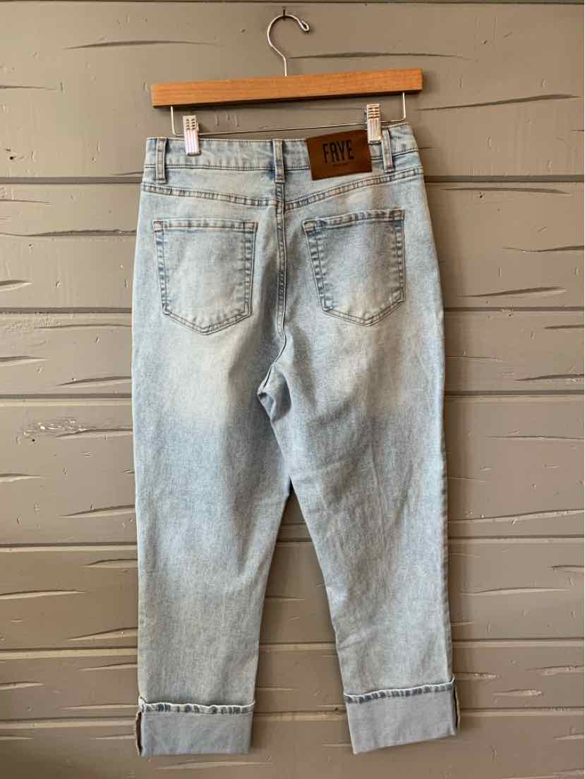 Light wash denim jeans with a cropped cuffed hem and back patch pockets.