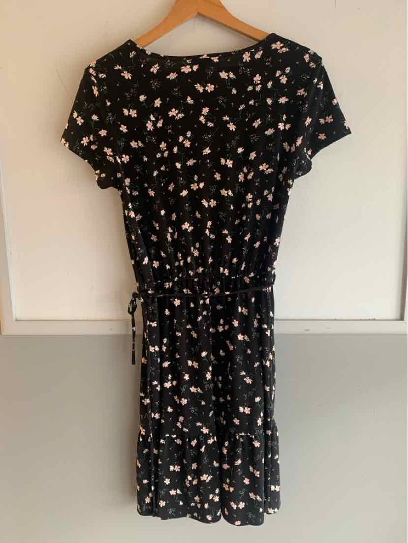 Black short-sleeve floral dress with cinched waist and small pink and white flowers.