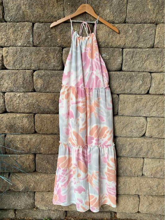 Sleeveless midi dress with halter neckline in soft pink and peach watercolor floral print.
