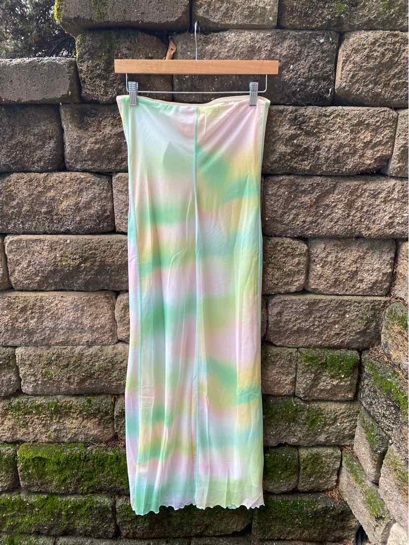 Long strapless dress with pastel rainbow tie-dye pattern and slight ruffled hem in lightweight fabric.