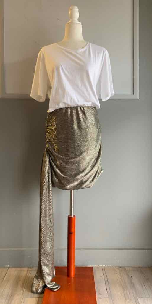 White short-sleeve wrap top paired with a metallic ruched skirt featuring a long side sash.