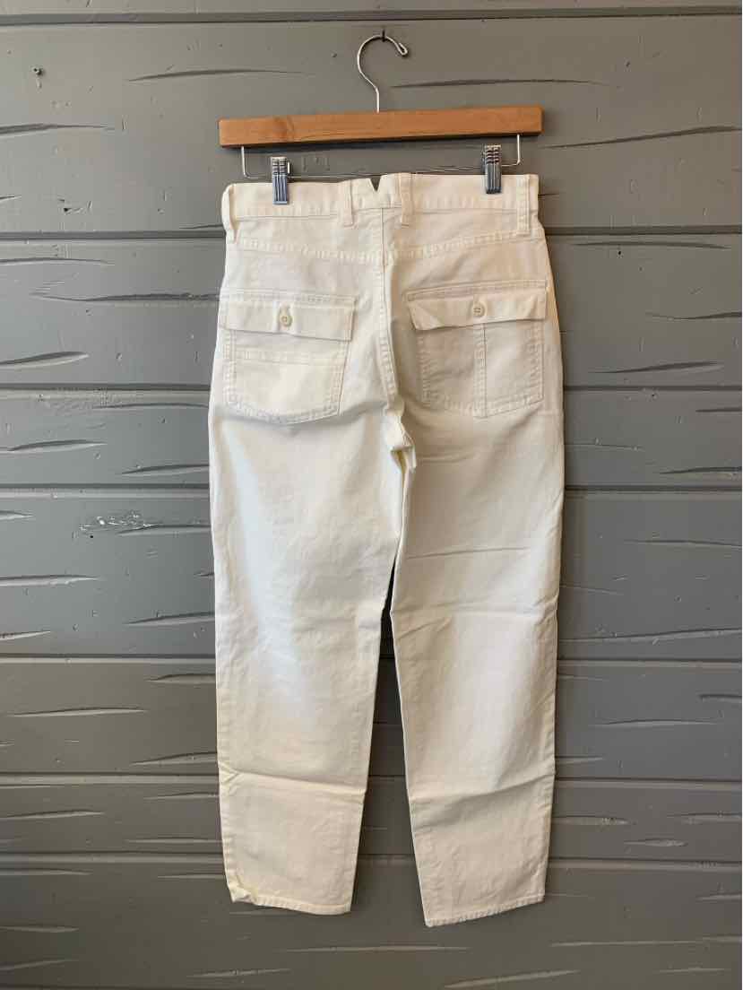 White high-waist straight-leg pants with back flap pockets and belt loops on wood hanger.