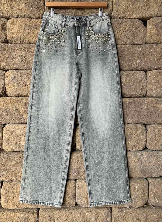 Gray acid-wash straight-leg jeans with front pockets and belt loops hanging on wooden hanger.