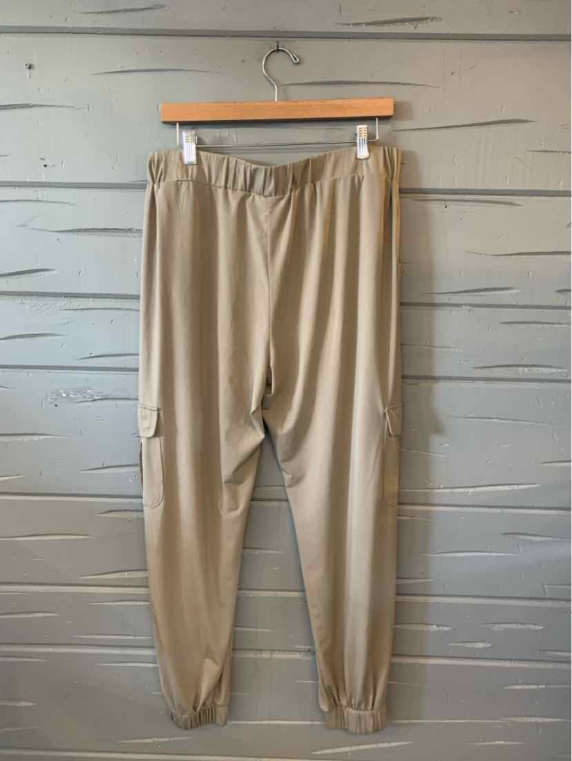 Tan Lisa Rinna pants with an elastic waistband, side pockets, and gathered ankle cuffs.